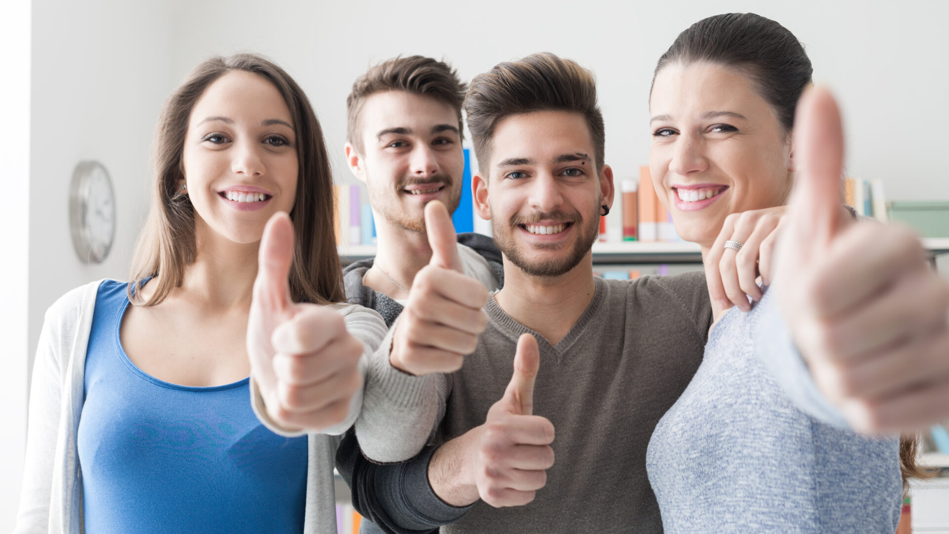 Cheerful students with thumbs up