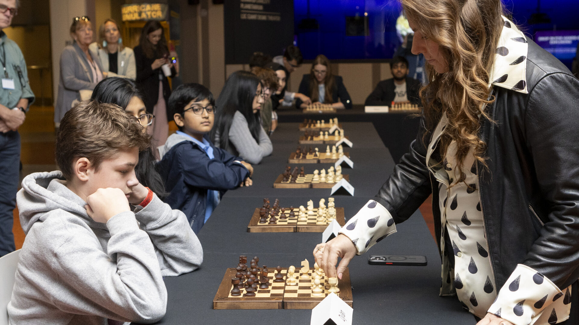 Judit Polgár playing chess with young players